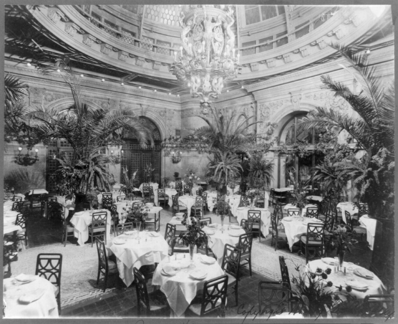 The Waldorf-Astoria’s ornate Palm Room, in which patrons<br>were required to wear formal attire,<br>was located at one end of the hotel’s legendary<br>“Peacock Alley.”